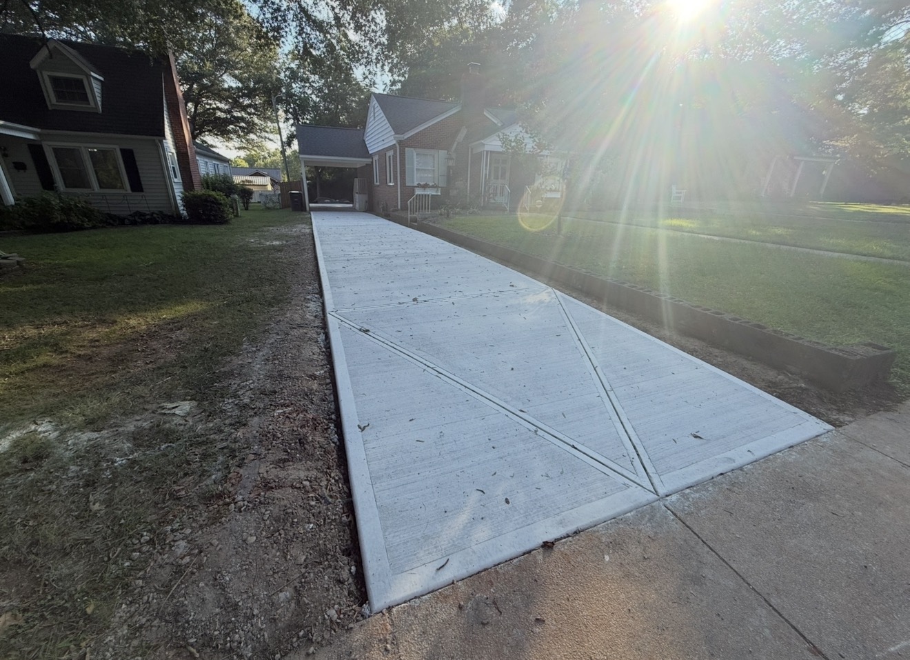Concrete driveway installation in Weddington, NC — poured slab, control joints, broom-finish surface by Local Concrete Charlotte.